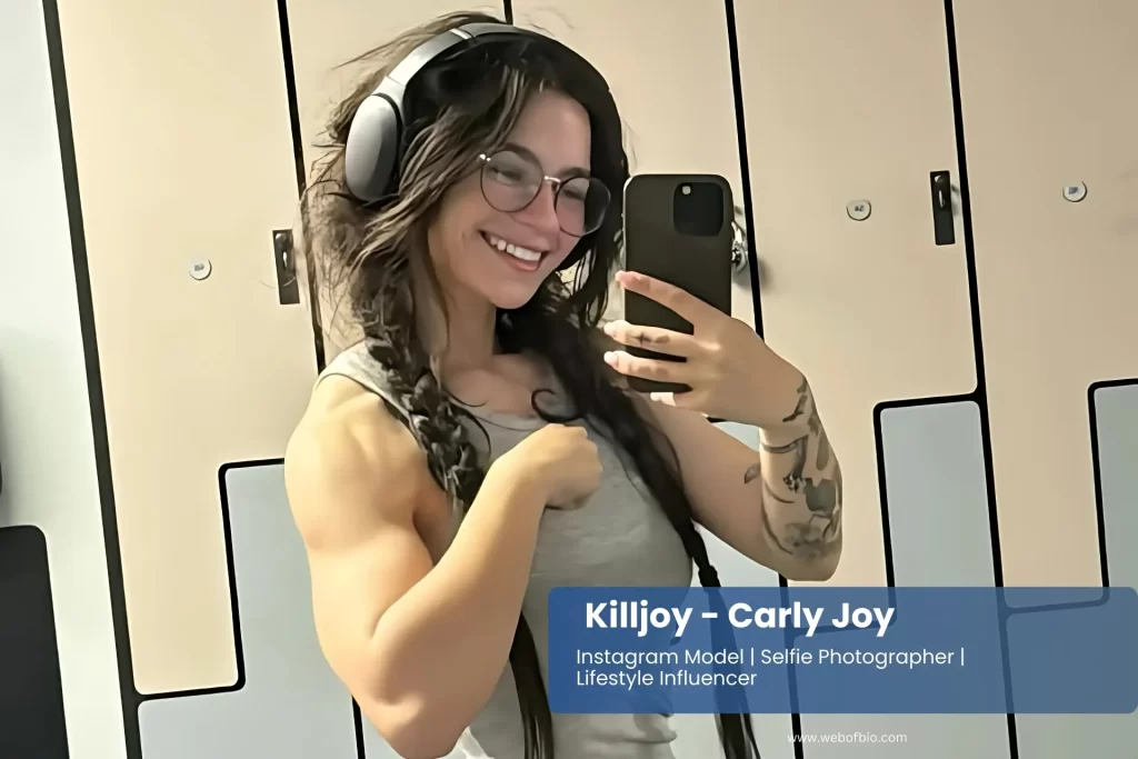 Killljoyy Carly flaunts bold tattoos and vibrant style in a TikTok-inspired selfie, celebrating individuality and social media creativity.