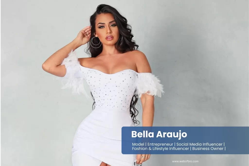 Bella Araujo in a white dress posing for the camera.