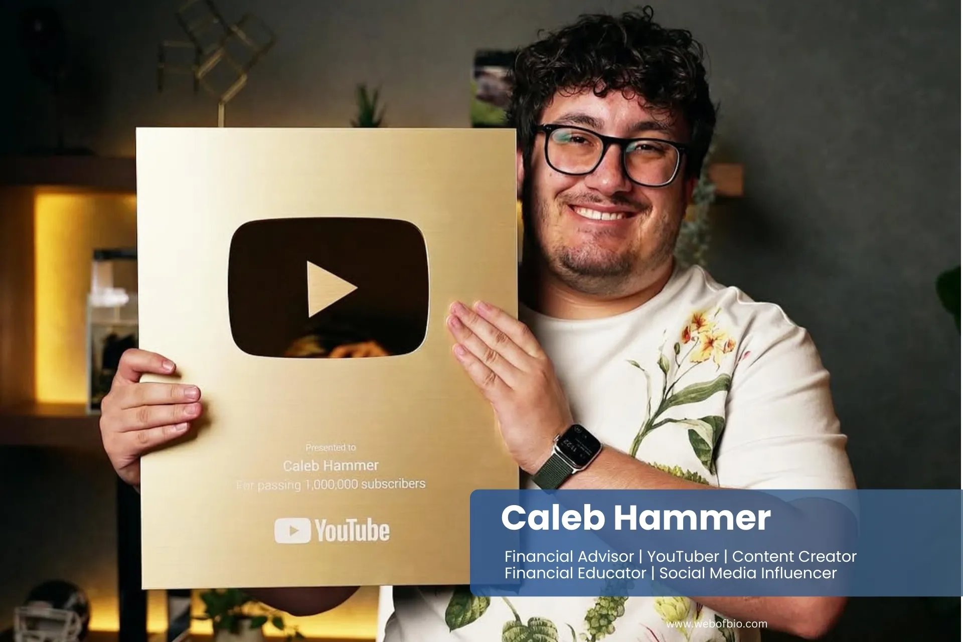 Caleb Hammer holding up a gold plaque with the YouTube logo on it.