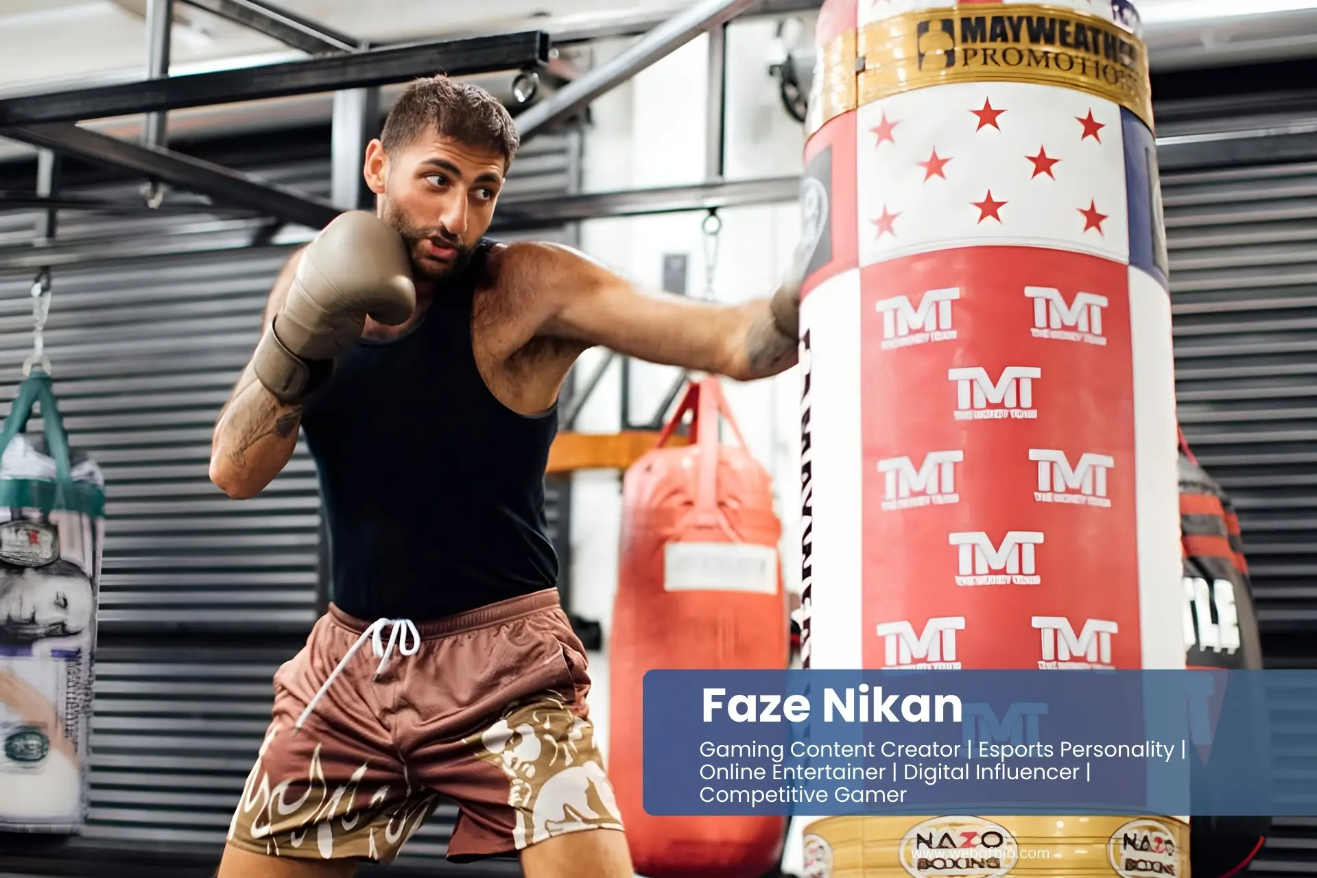 Faze Nikan in shorts and a tank top is hitting a punching bag.