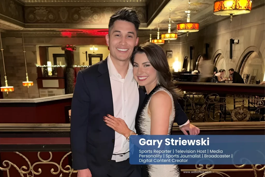 Gary Striewski posing with Abbey Carnivale for a photo in a hotel lobby.