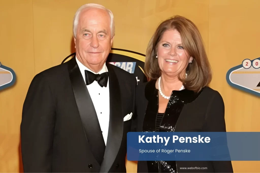 Kathy Penske with partner standing on a red carpet.