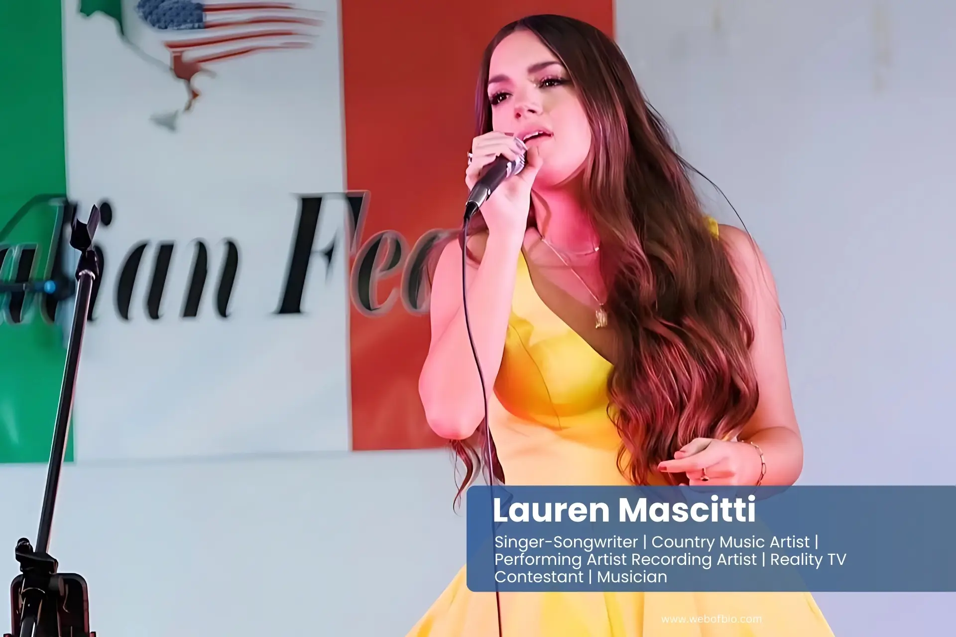 Lauren Mascitti in a yellow dress singing into a microphone.