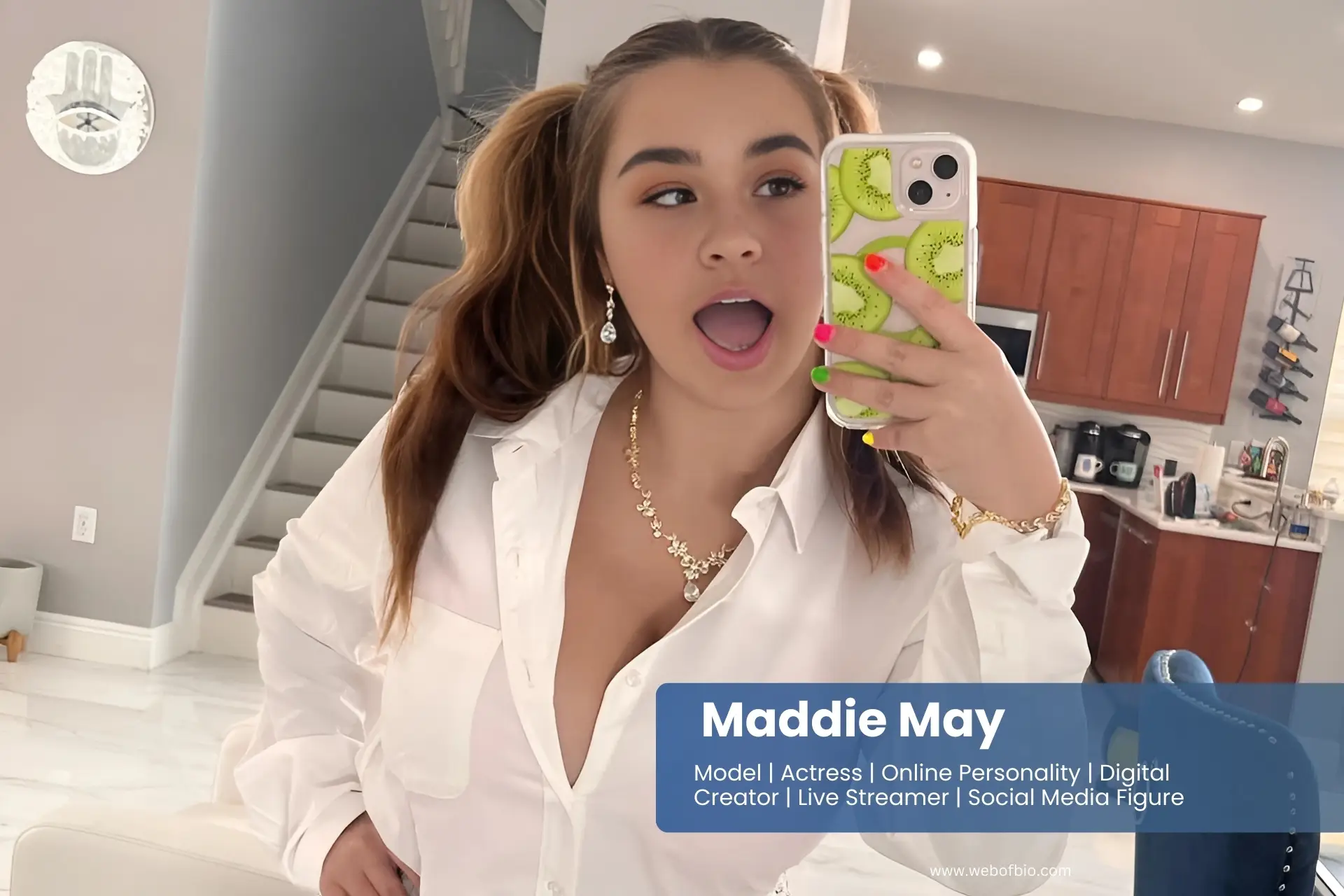 Maddie May in a white shirt taking a selfie.