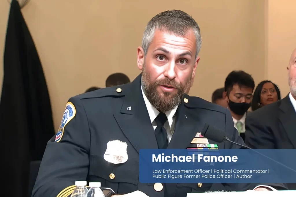 Michael Fanone is in uniform, sitting at a table.