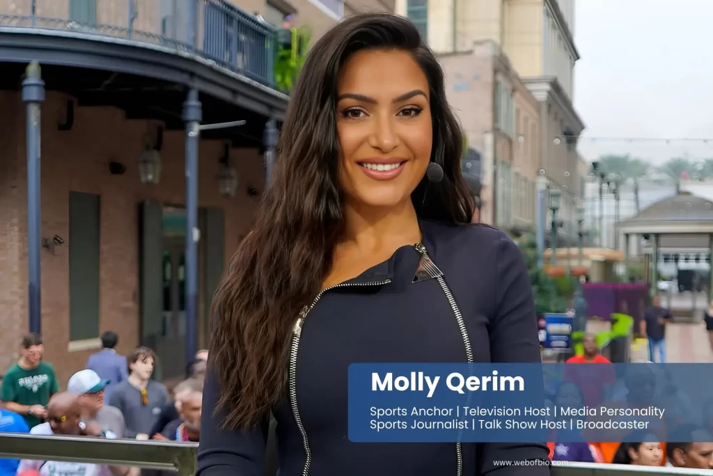 Molly Qerim in a black dress standing in front of a crowd.
