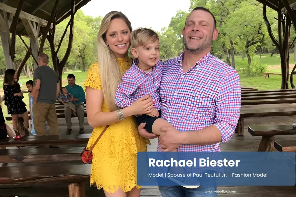 Rachael Biester, with her family, pose for a photo in front of a pavilion.
