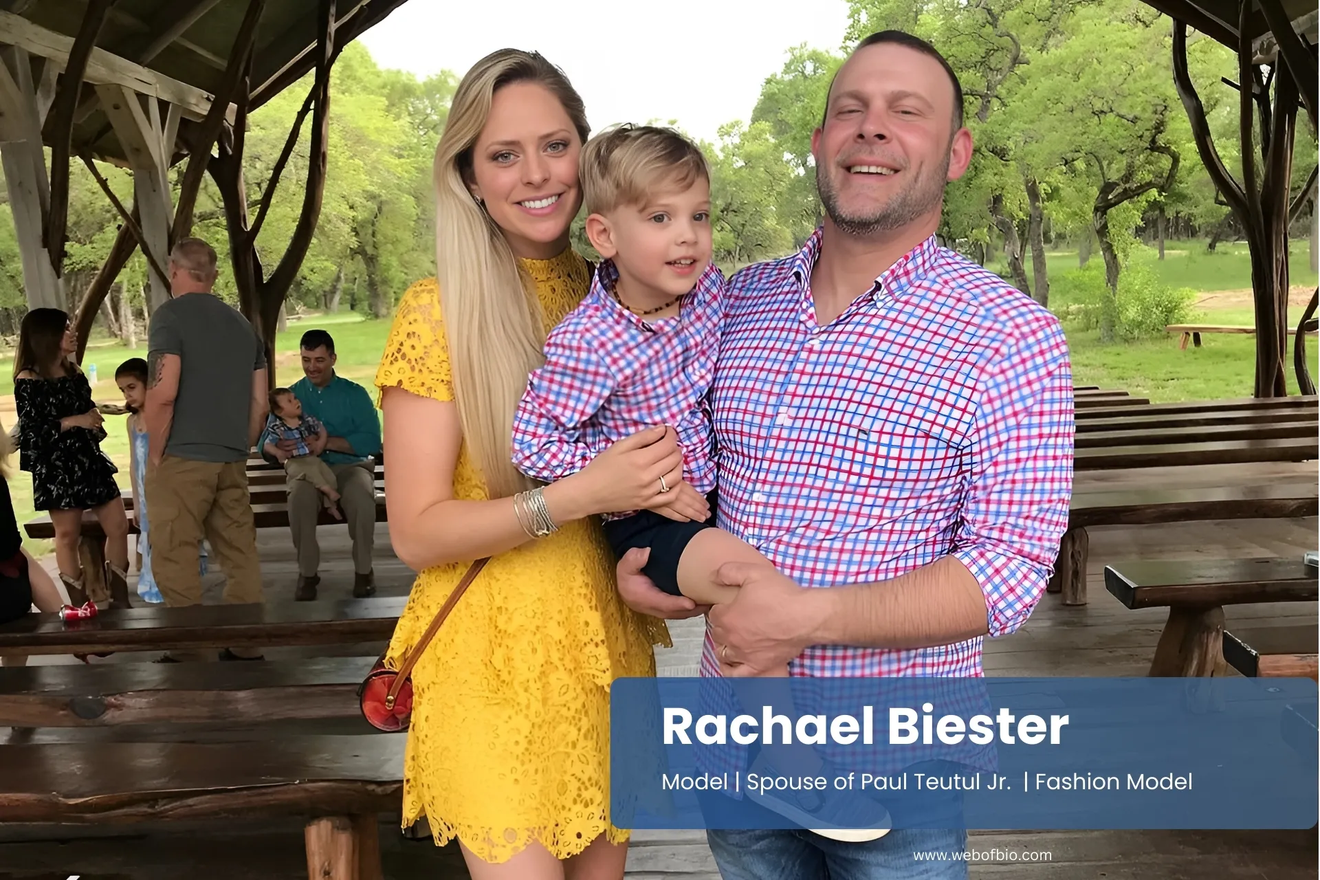 Rachael Biester, with her family, pose for a photo in front of a pavilion.