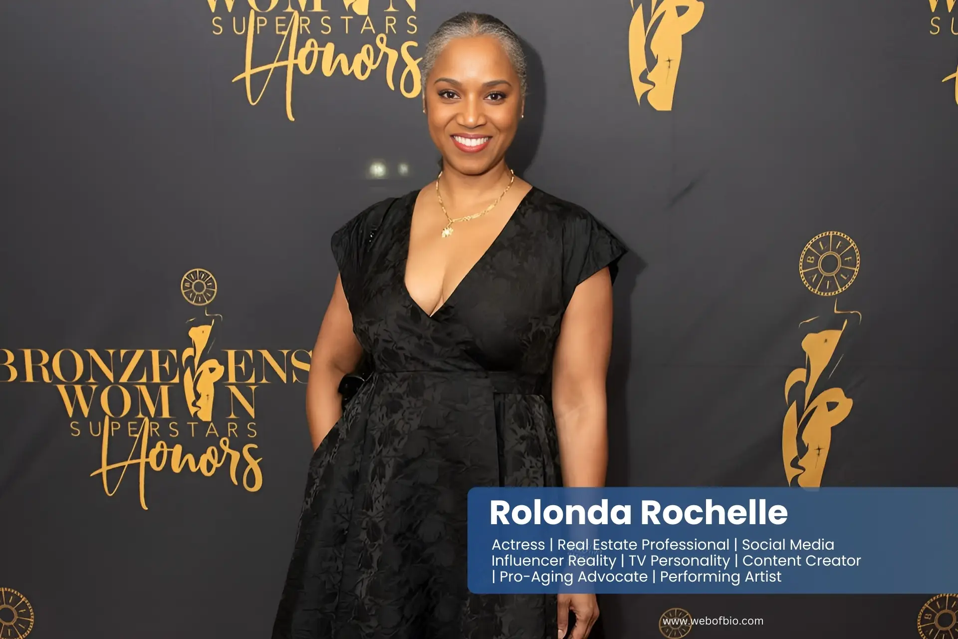 Rolonda Rochelle in vibrant red carpet at the Emmy Awards, lined with photographers and celebrities arriving for the prestigious event.