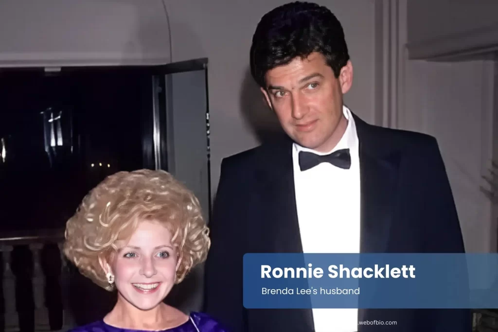 Ronnie Shacklett and his wife Brenda Lee in formal attire stand side by side, both smiling and looking towards the camera.