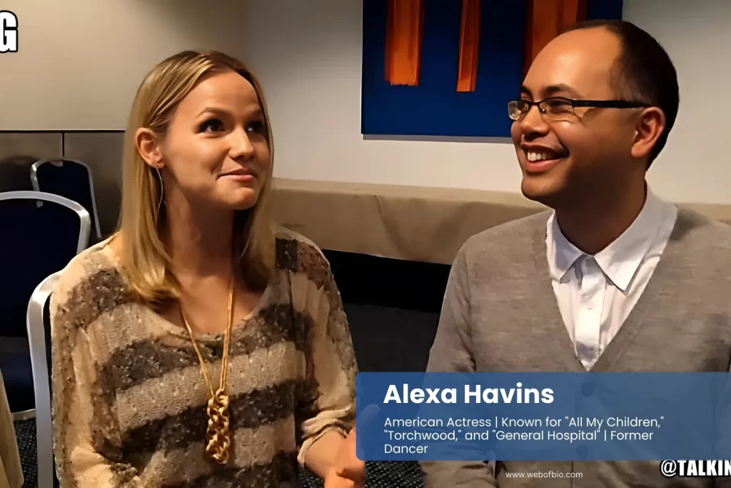 Alexa Havins and his friend sit next to each other, both looking at each other while talking.