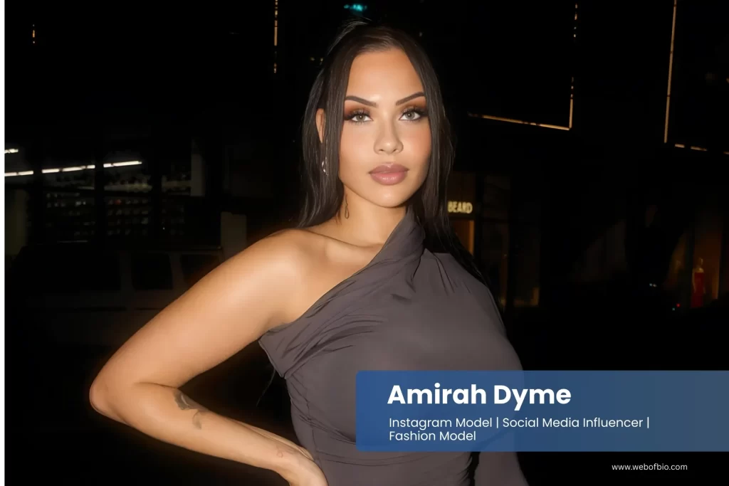 Amirah Dyme in a grey dress is posing for the camera.