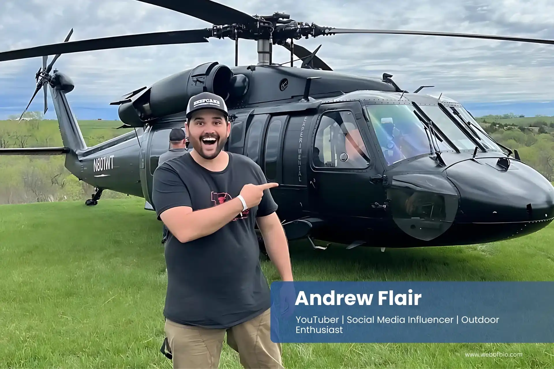 Andrew Flair standing in front of a black helicopter.