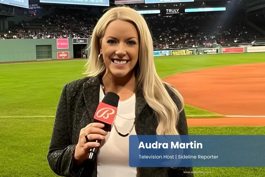 Audra Martin is reporting for TV on the baseball field at night under stadium lights.