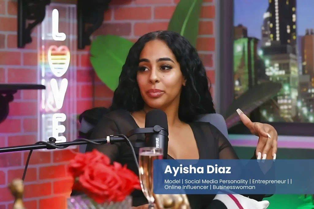 Ayisha Diaz is sitting in front of a microphone.