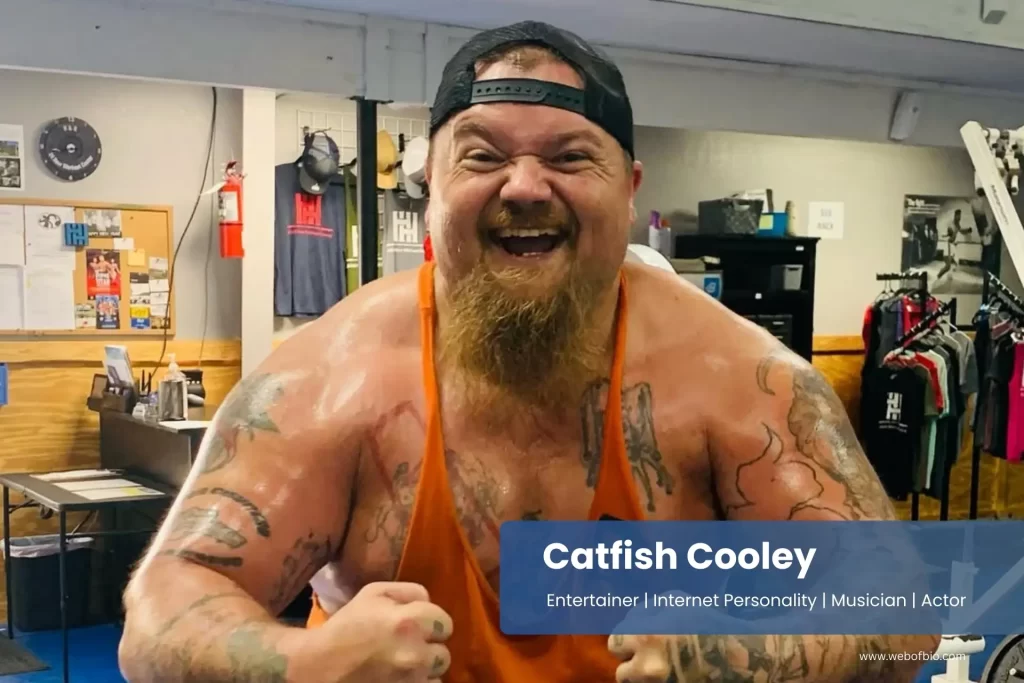 Catfish Cooley with a beard and tattoos in a gym.