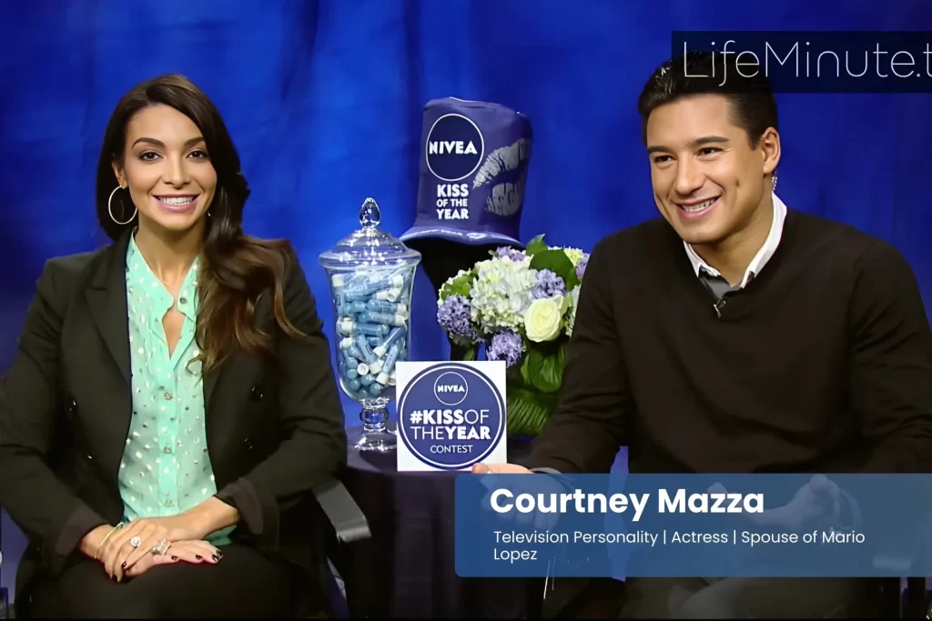 Courtney Mazza and Mario Lopez sitting next to each other on a blue couch