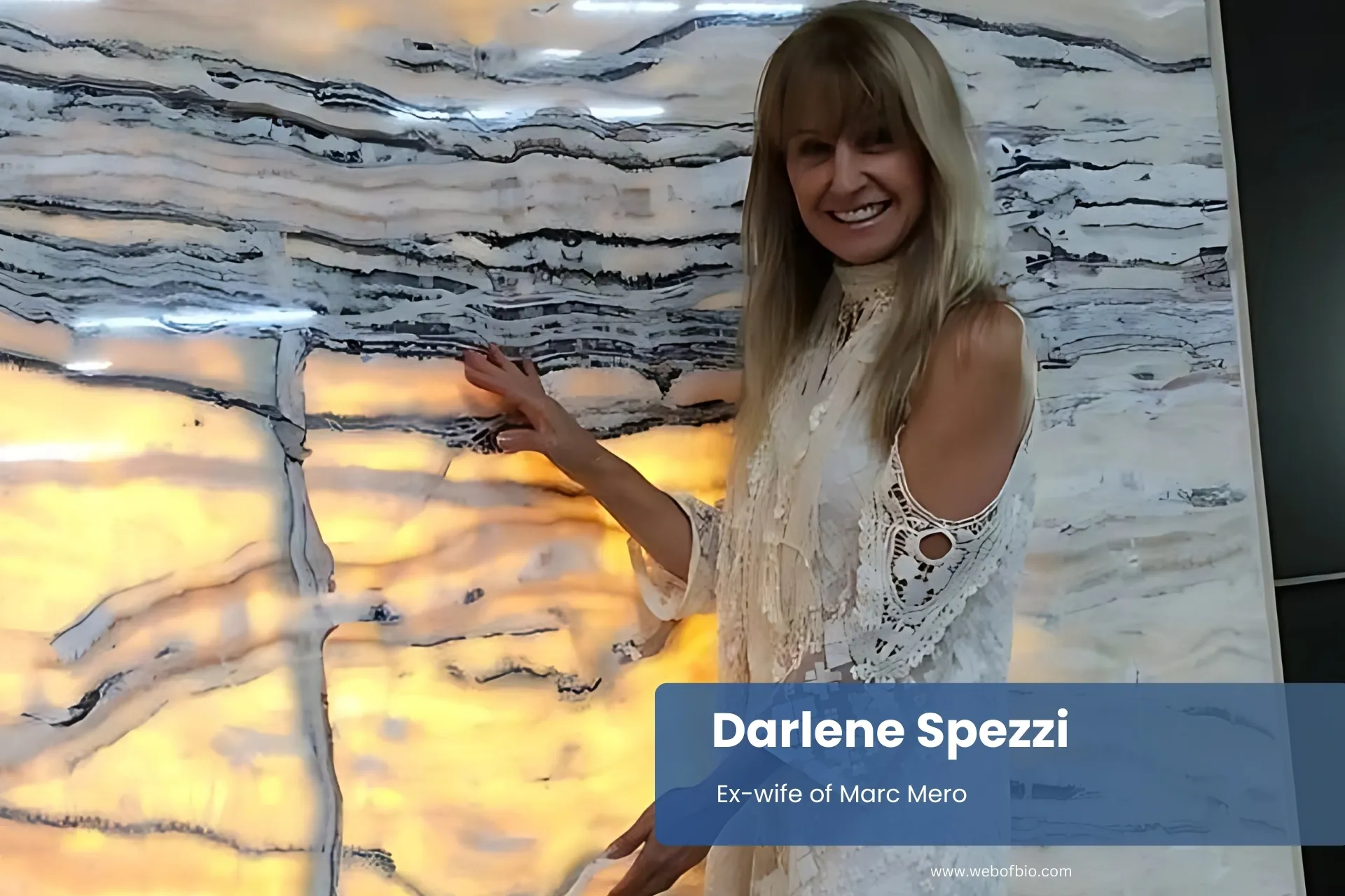 Darlene Spezzi standing beside large marble slab.