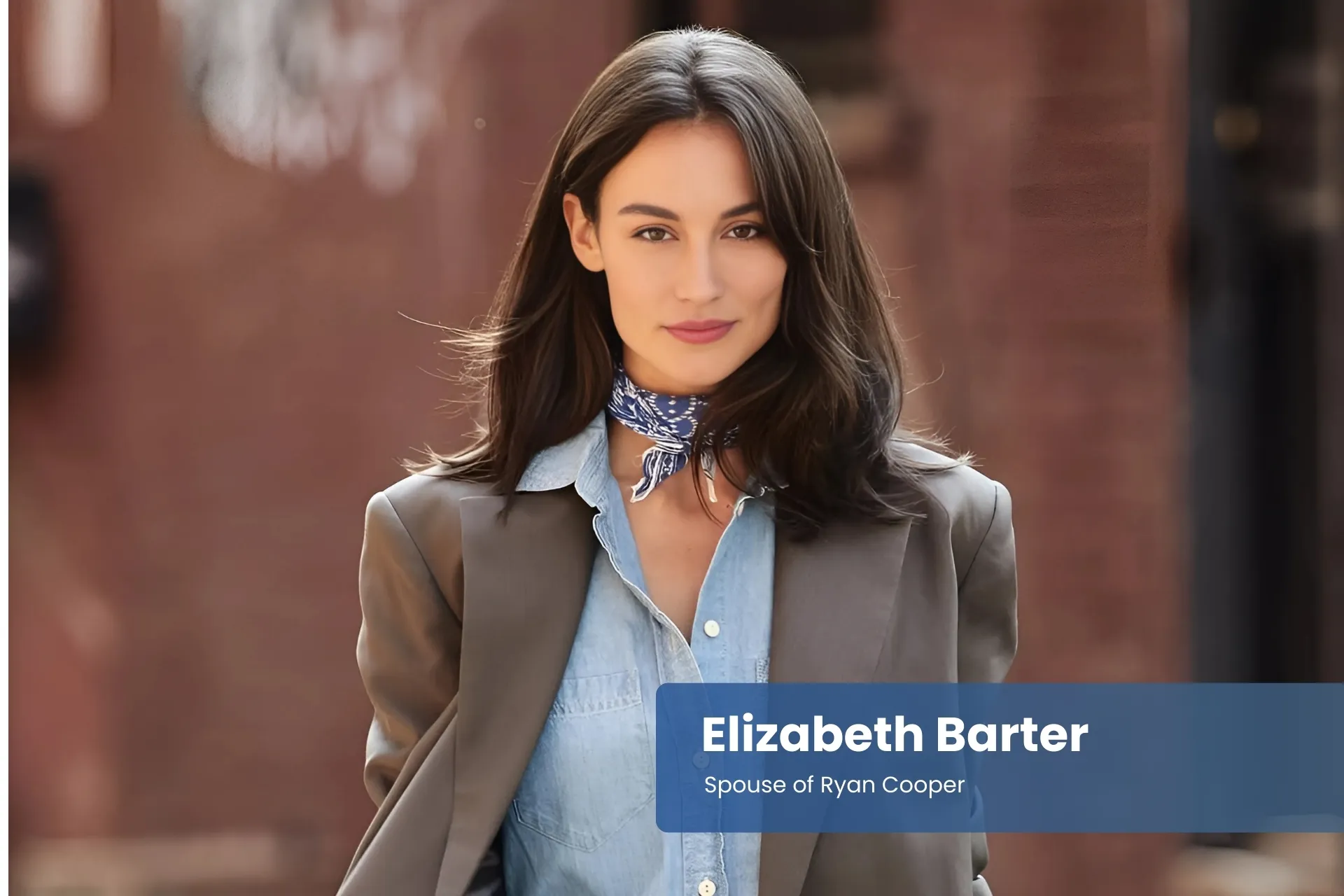 Elizabeth Barter in a denim shirt and blazer walking down the street.