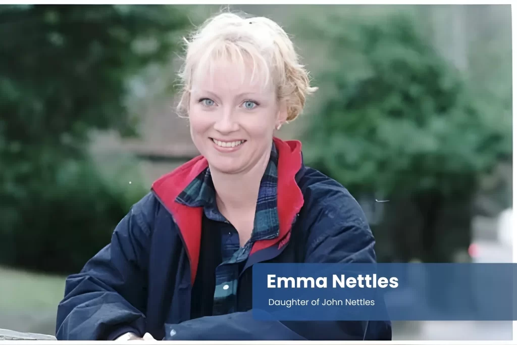 Emma Nettles - Daughter of John Nettles, in a blue jacket, sitting on a bench.