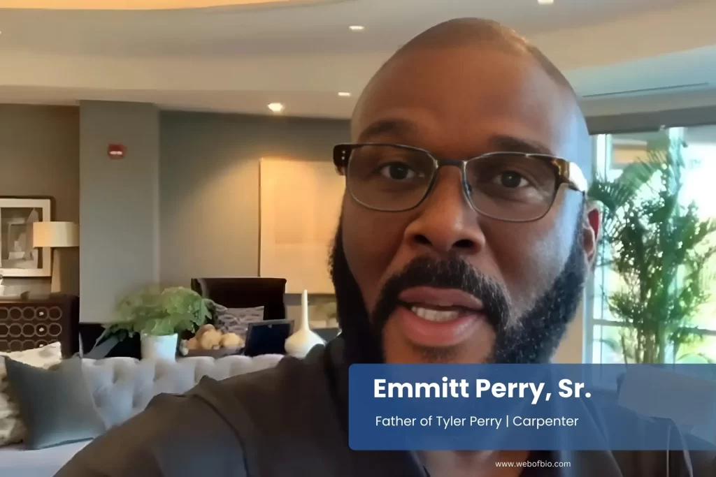 Emmitt Perry Sr with glasses and beard speaking to camera.