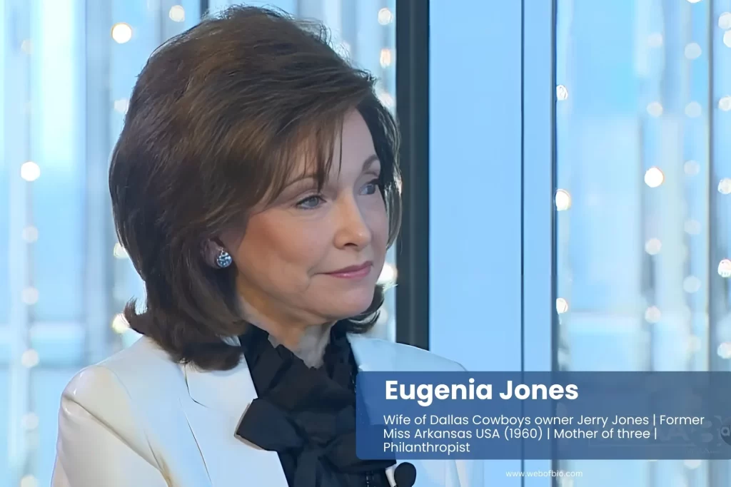 Eugenia Jones in white jacket and black tie exuding professionalism.