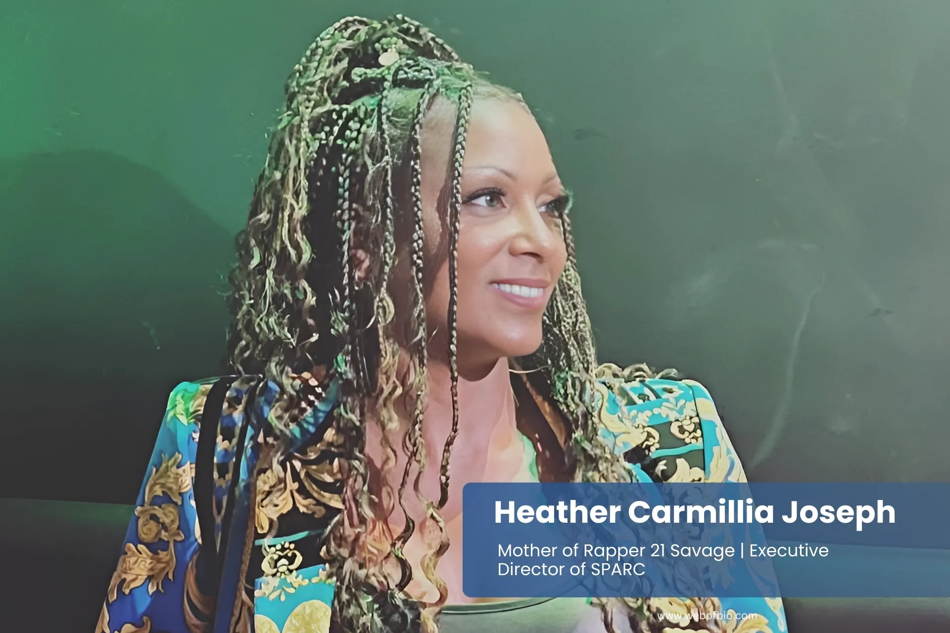 Heather Carmillia Joseph with braids smiling on couch.