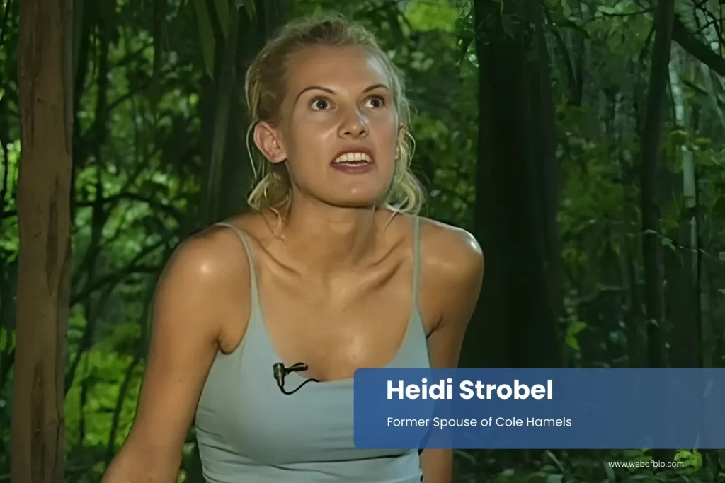 Heidi Strobel in a blue tank top sitting in the woods.