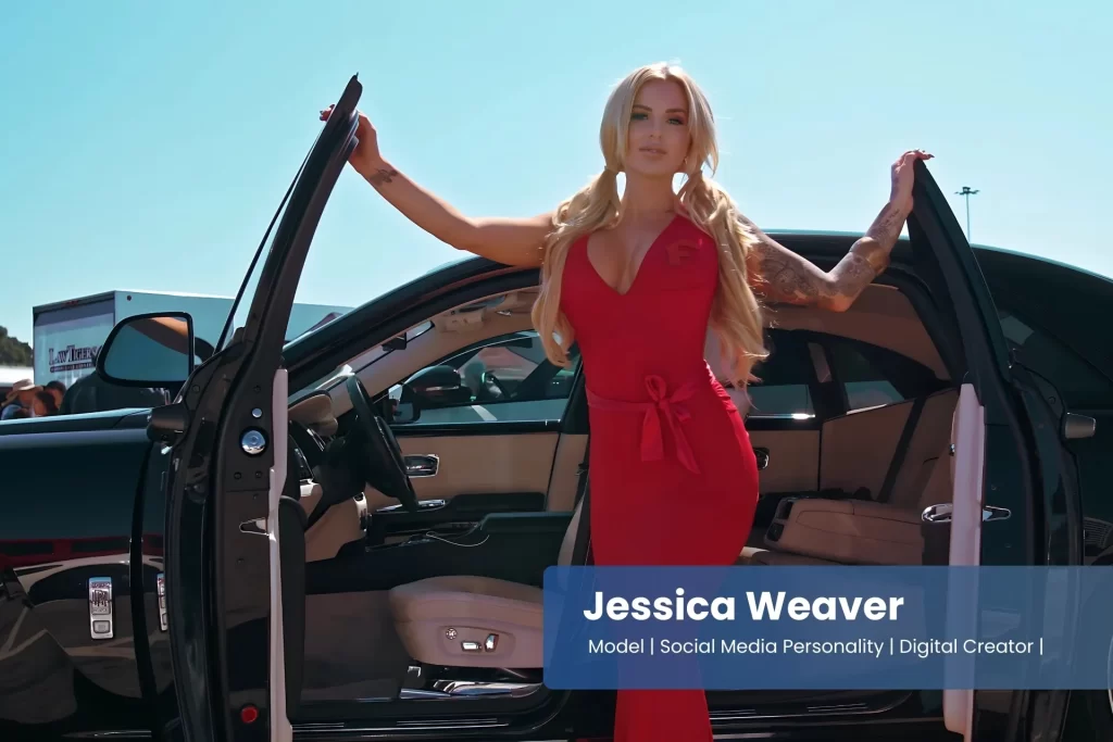 Jessica Weaver in a red dress standing next to a car.
