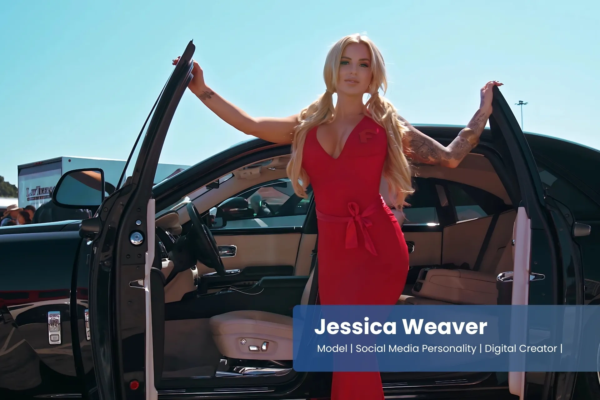 Jessica Weaver in a red dress standing next to a car.