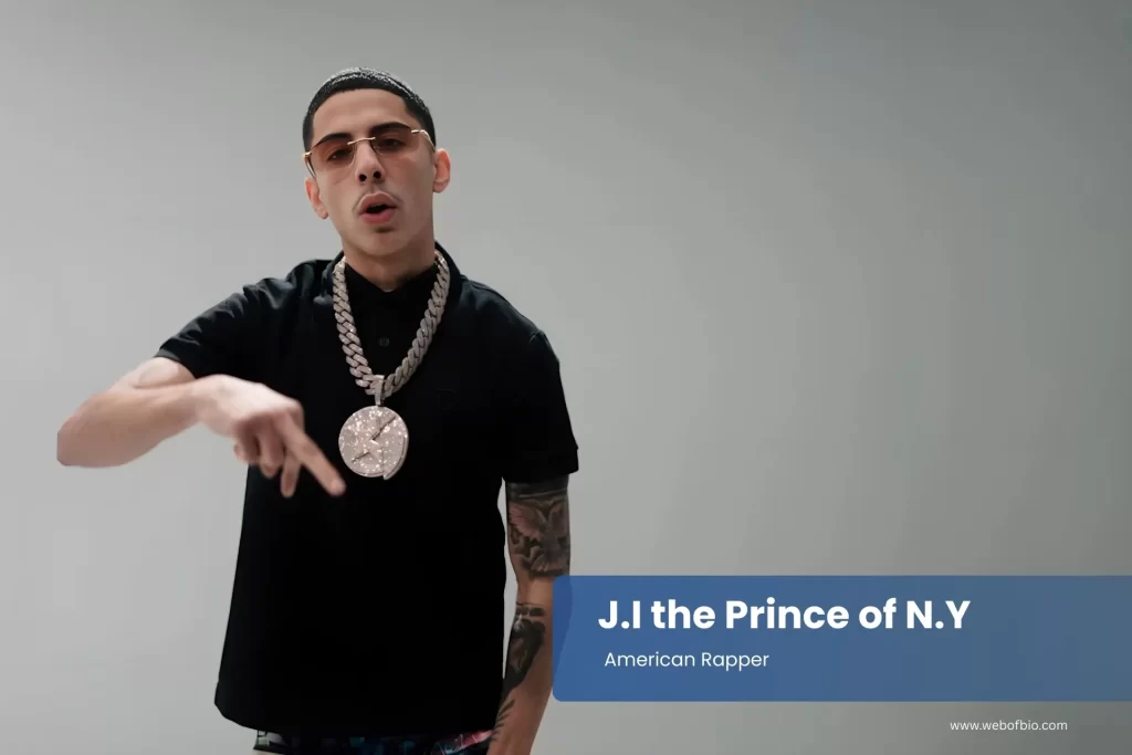 J.I the Prince of N.Y in a black shirt with a chain on their neck.