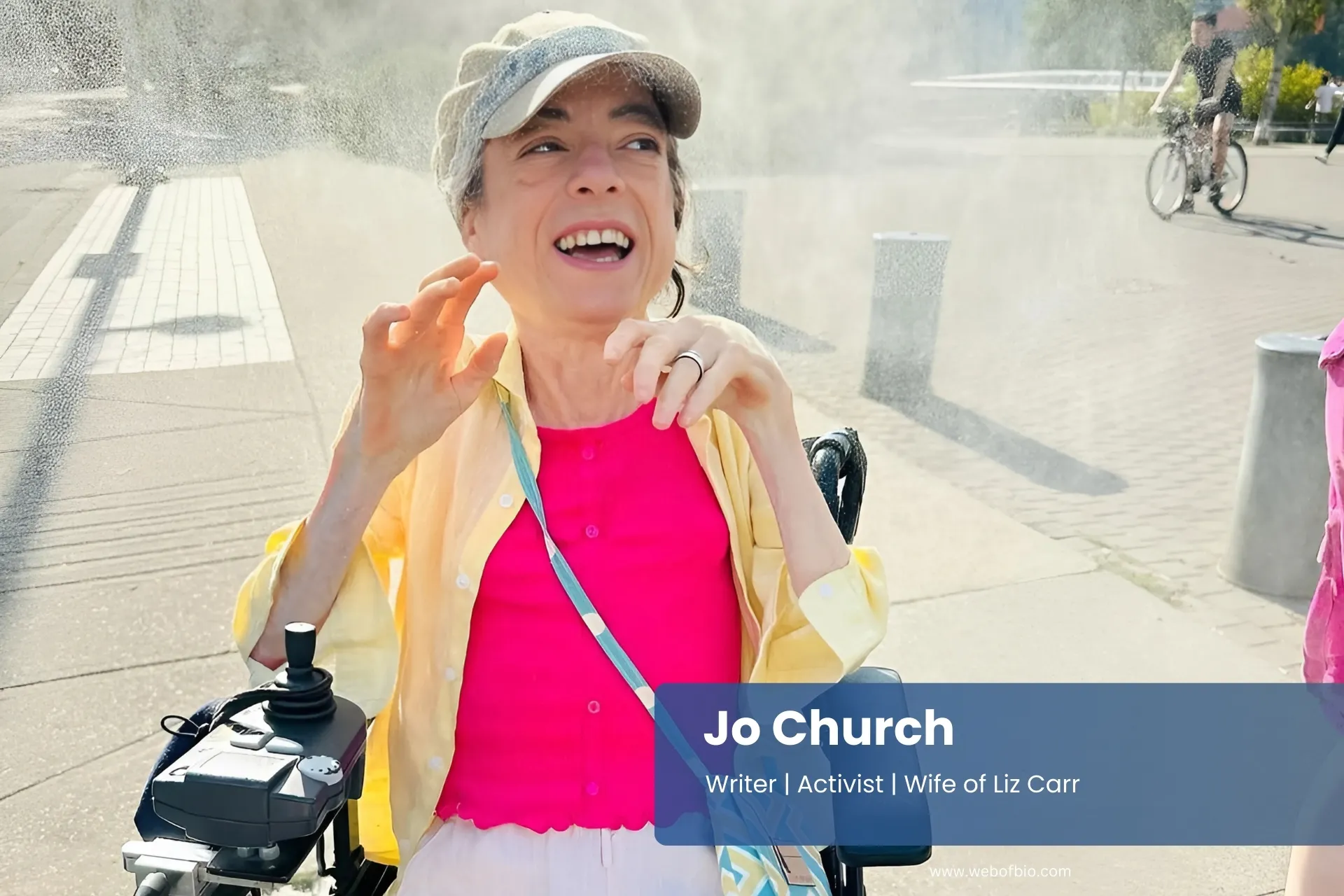 Jo Church wheelchair enjoying water spray.