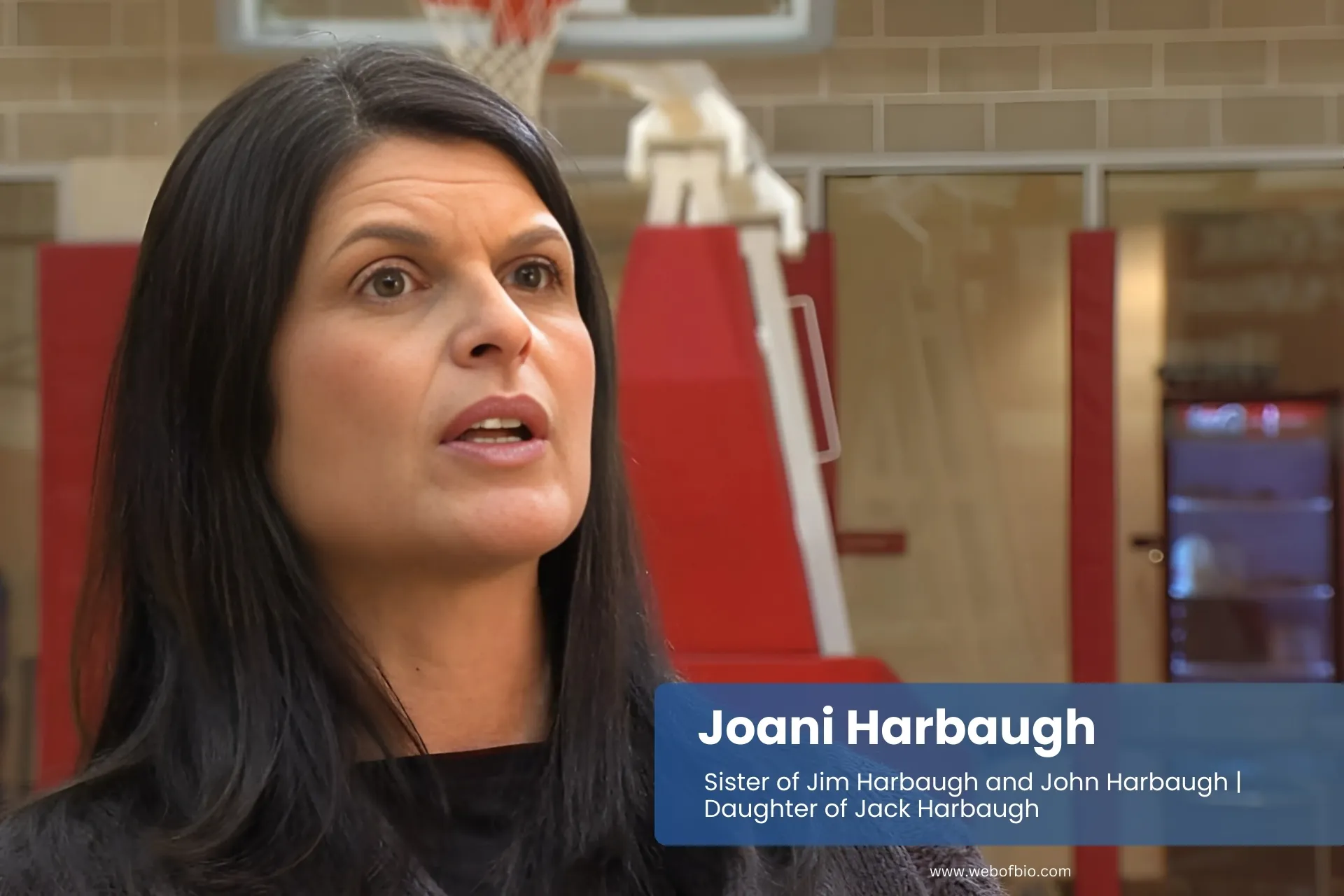 Joani Harbaugh standing on a basketball court.