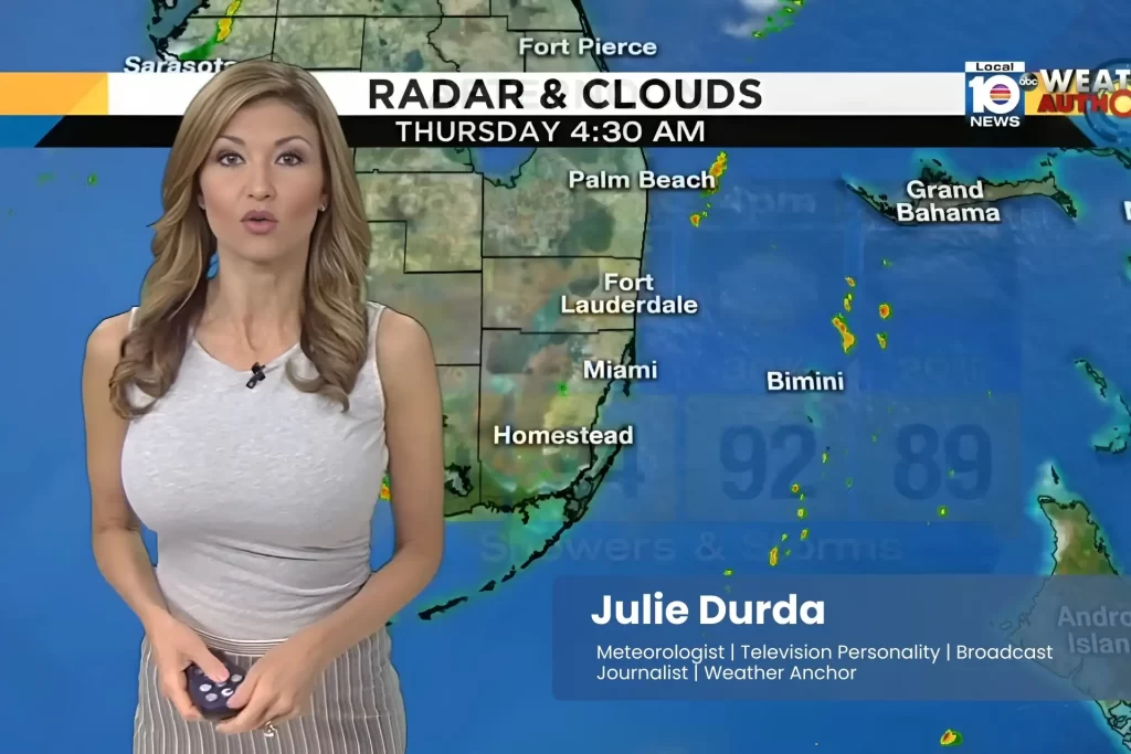 Julie Durda is standing in front of a weather map.