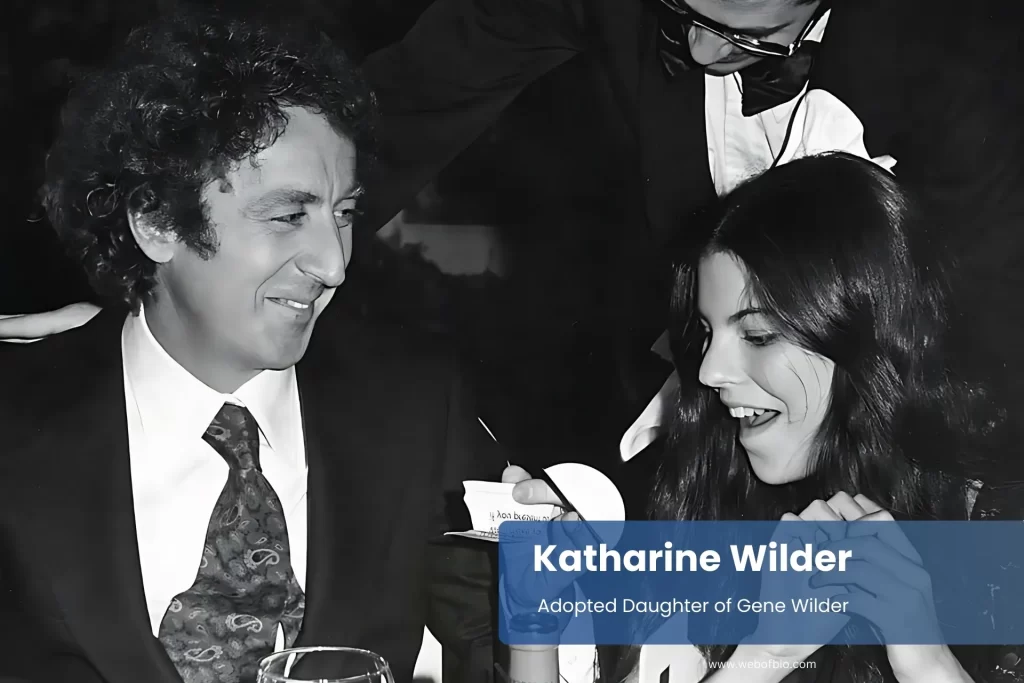 Katharine Wilder and her father, Gene Wilder, eat at a table, and the man holding a glass is conversing.