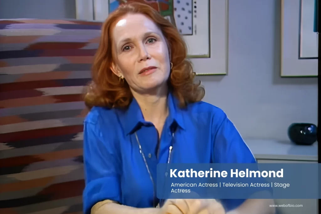 Katherine Helmond in a blue shirt is sitting at a table.