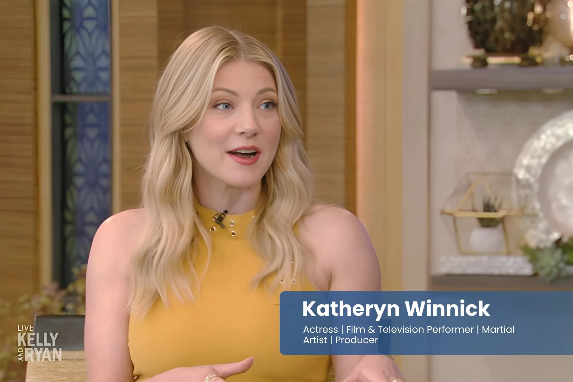 Katheryn Winnick in a yellow dress is talking on the set of the today show.