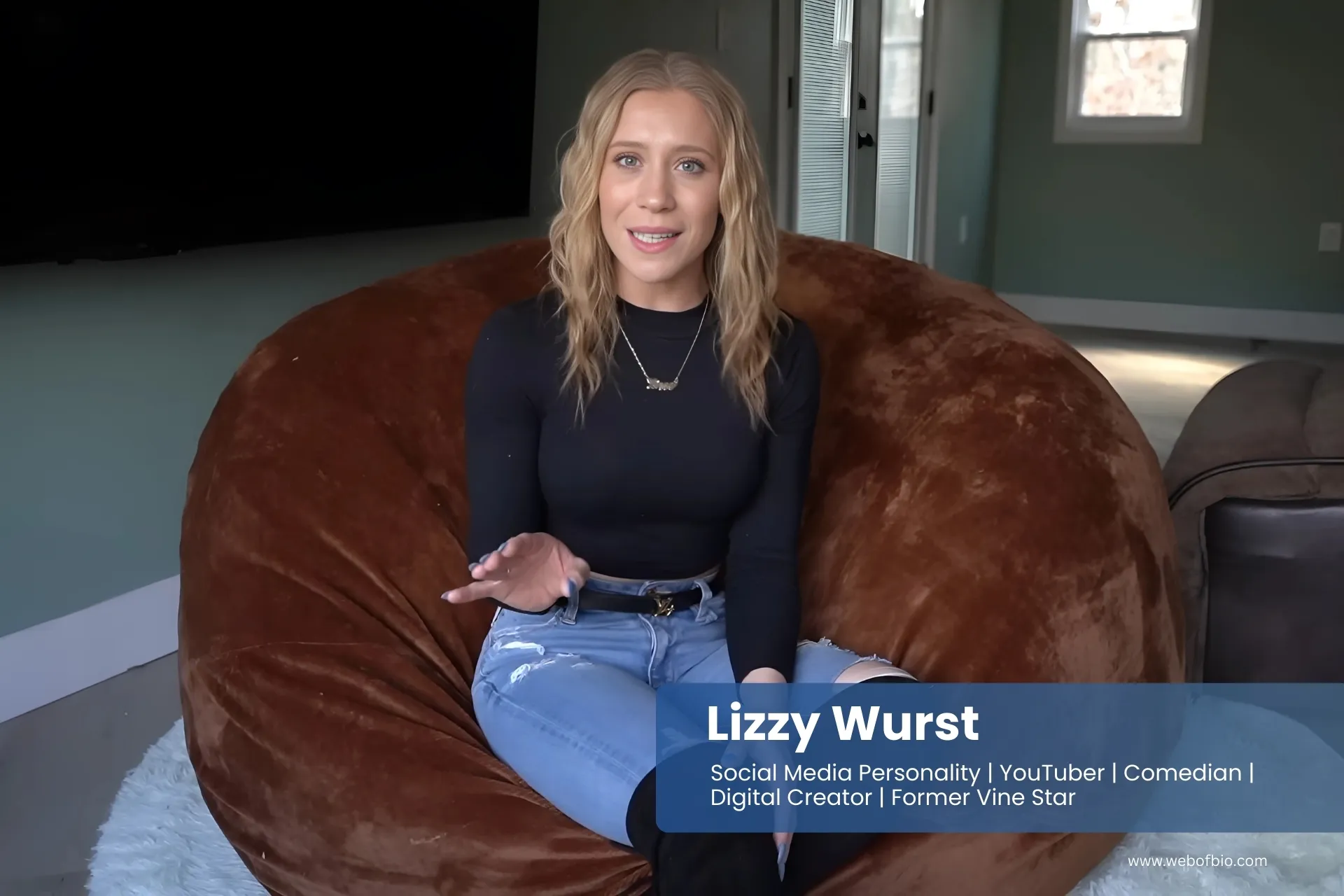 Lizzy Wurst sitting on a large bean bag chair.