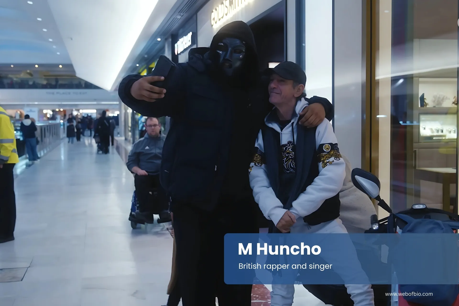 M Huncho posing for a picture in an airport.