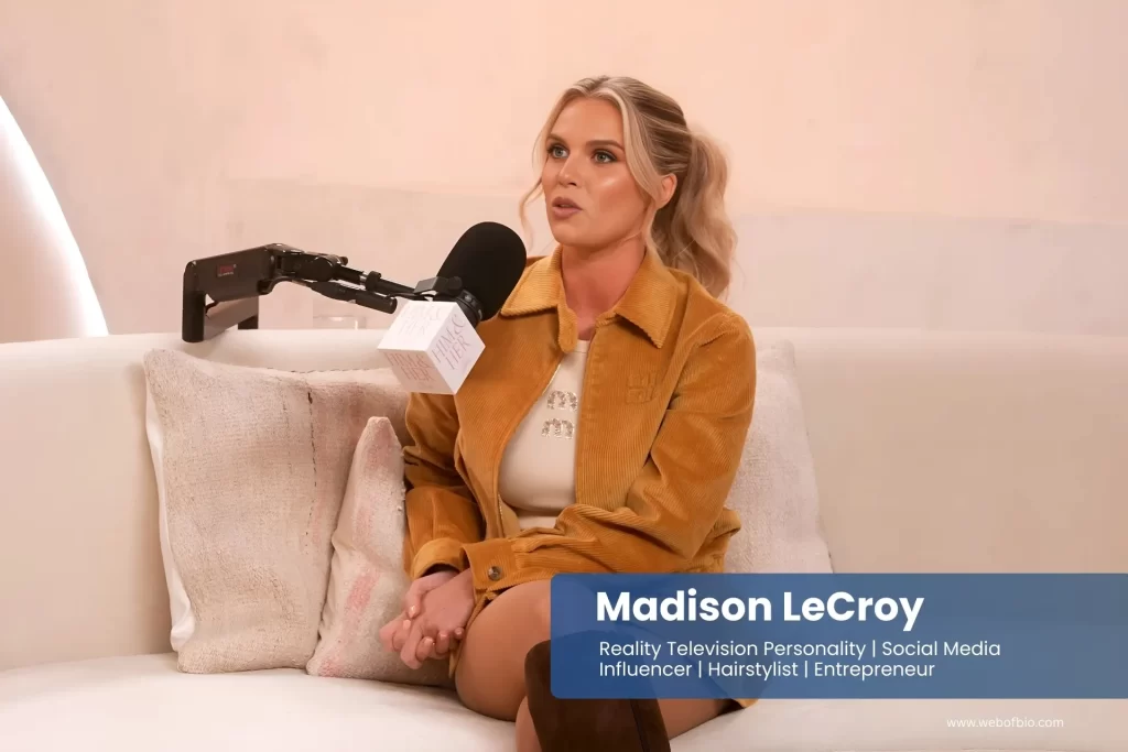 Madison LeCroy sitting on a couch with a microphone.