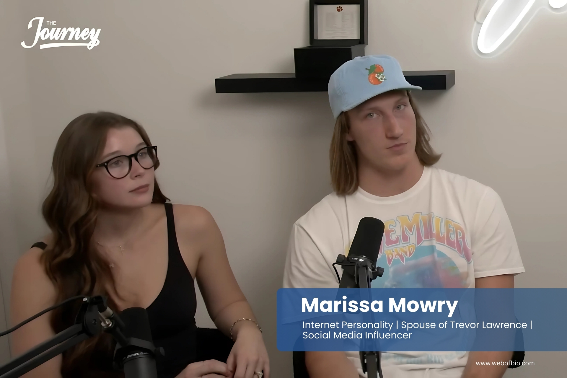 Marissa Mowry and Trevor Lawrence are sitting in front of a microphone.