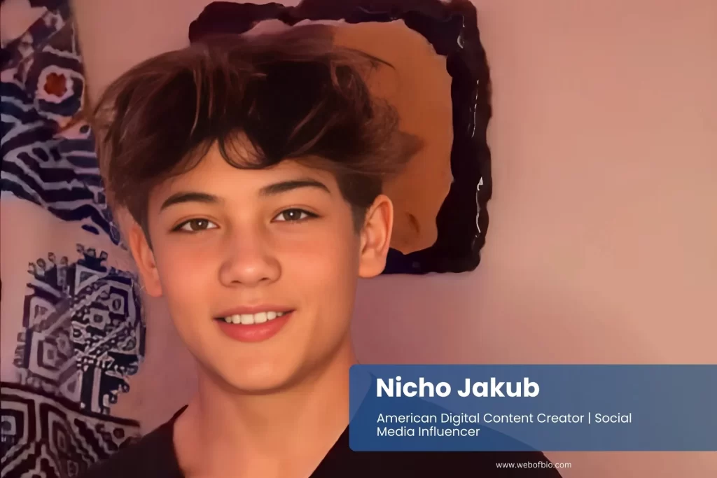 Nicho Jakub wearing a black shirt smiles warmly at the camera.
