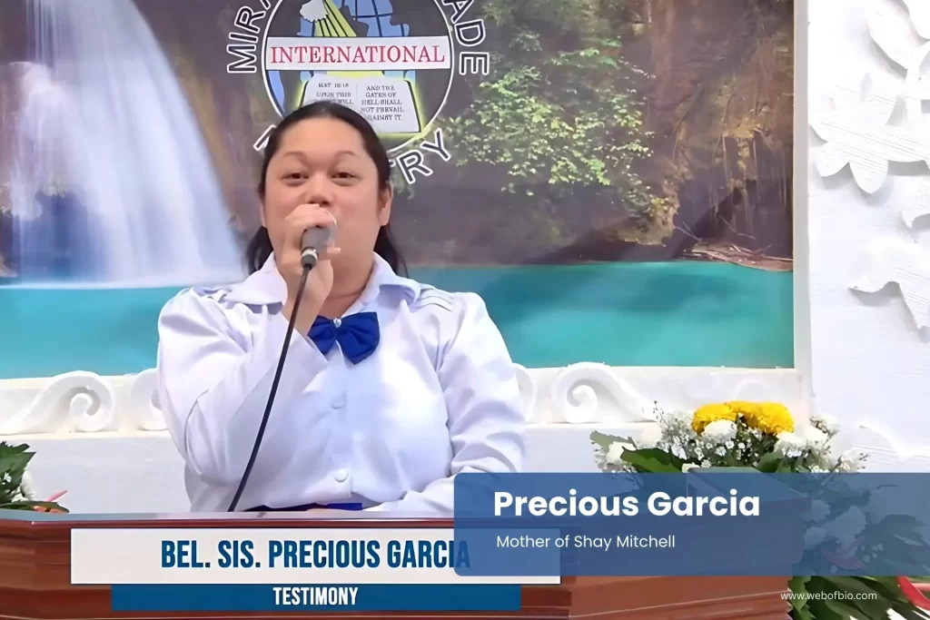 Precious Garcia is speaking into a microphone.