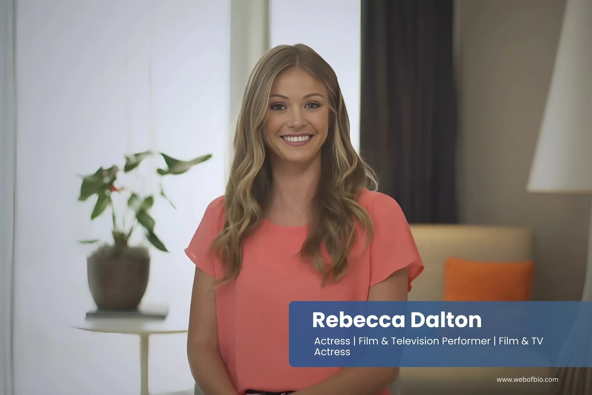 Rebecca Dalton in an orange top is smiling for the camera.