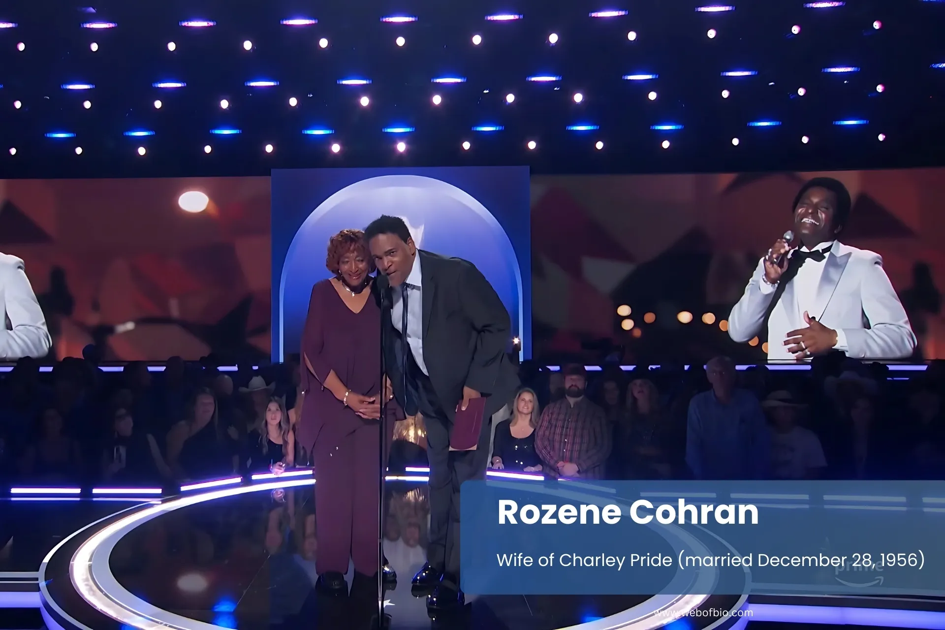 Rozene Cohran and Charley Pride standing stage large screen.