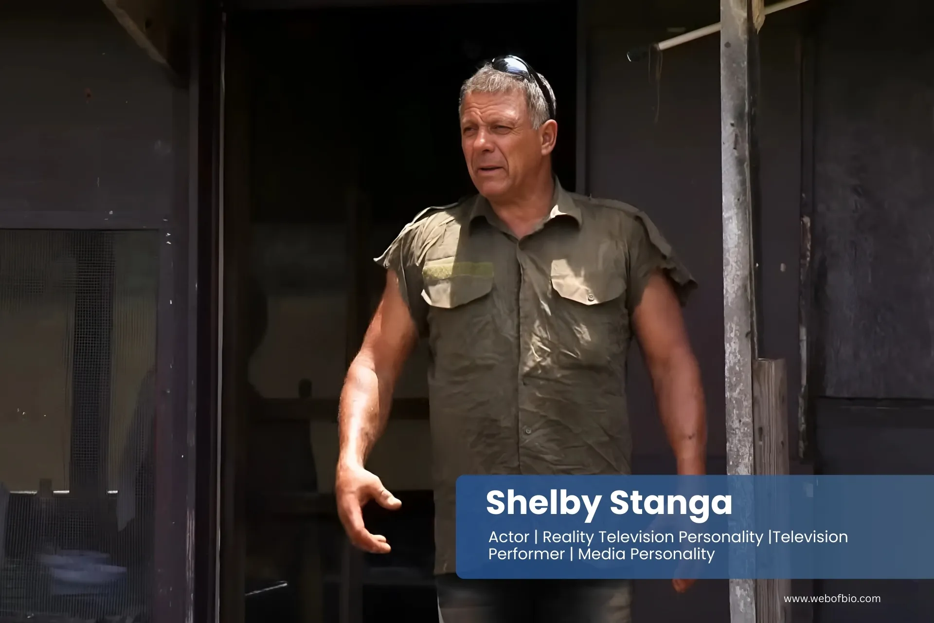Shelby Stanga in a green shirt standing in front of a building.