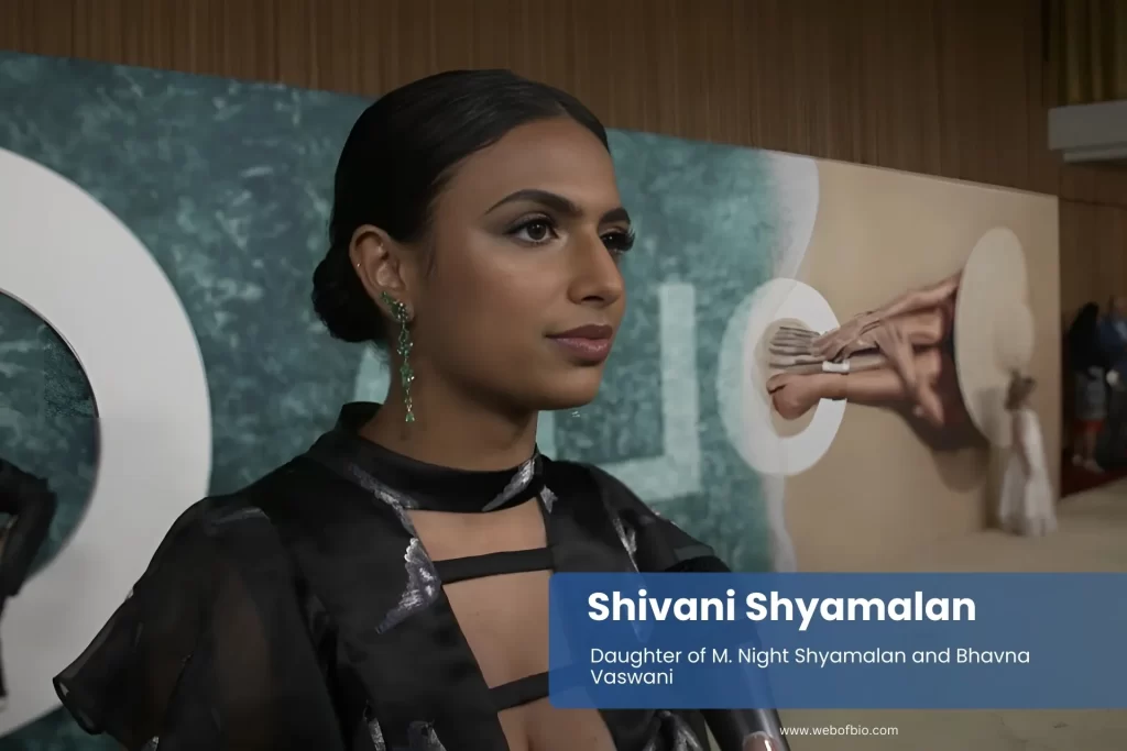 Shivani Shyamalan in a black dress talking to the camera