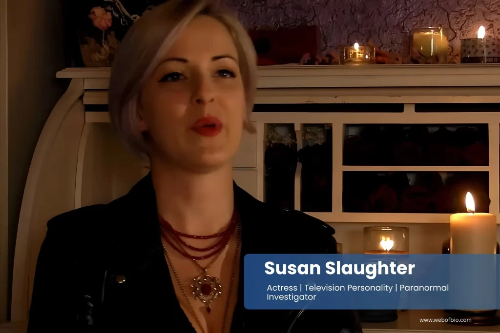 Susan Slaughter is sitting in front of a table with candles.