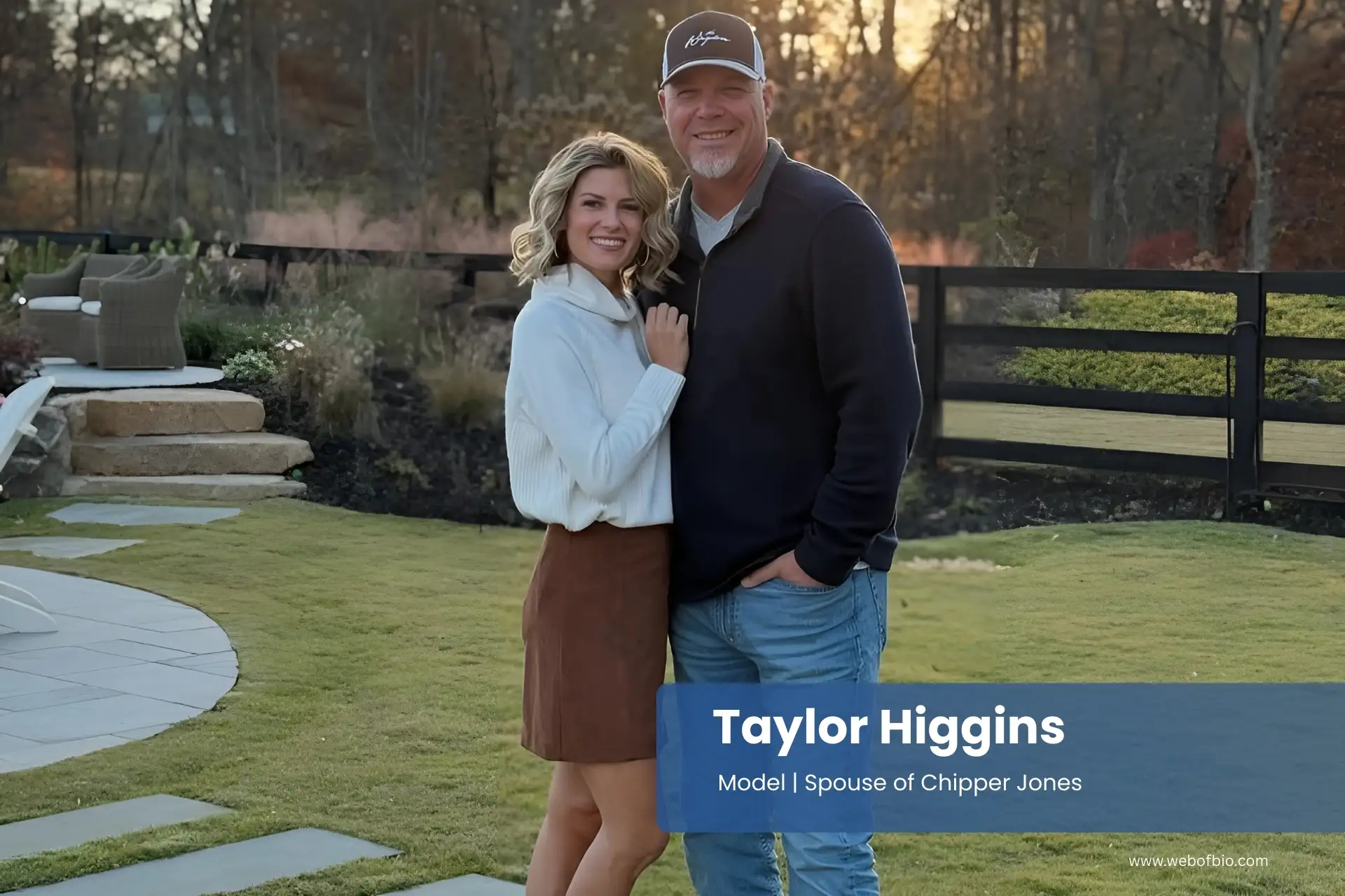 Taylor Higgins and Chipper Jones are standing on a stone walkway in front of a house.