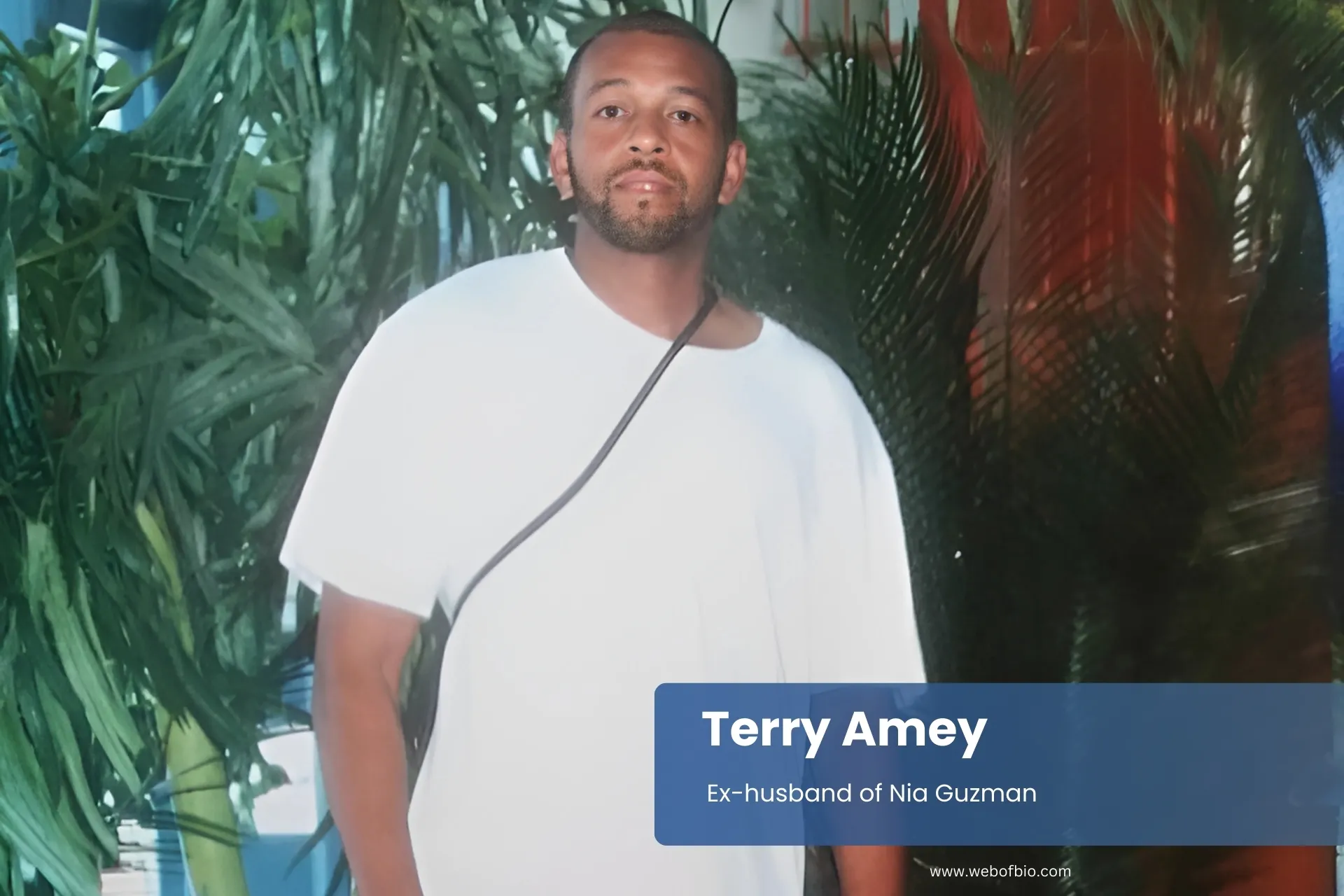 Terry Amey standing in front of a plant.